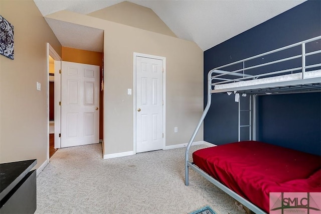 bedroom featuring lofted ceiling and carpet floors