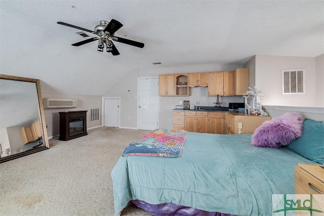 bedroom with lofted ceiling, sink, a wall mounted AC, a textured ceiling, and ceiling fan