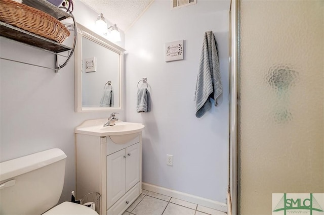 bathroom featuring tile patterned floors, vaulted ceiling, a textured ceiling, vanity, and a shower with door