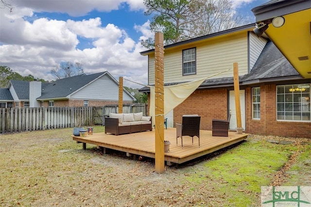 back of house with outdoor lounge area, a yard, and a deck