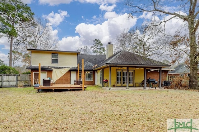 rear view of house featuring a wooden deck, a yard, and central air condition unit