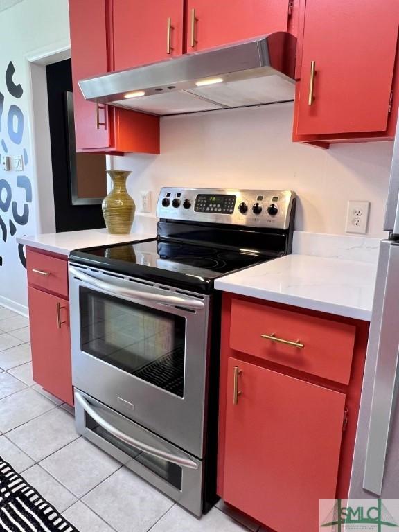 kitchen featuring stainless steel electric range oven and light tile patterned floors