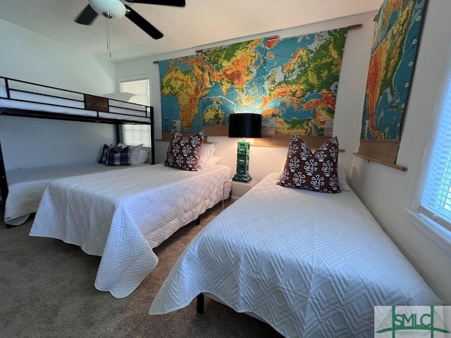 carpeted bedroom featuring multiple windows and ceiling fan