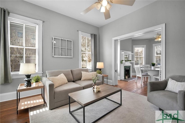 living room featuring hardwood / wood-style floors and ceiling fan