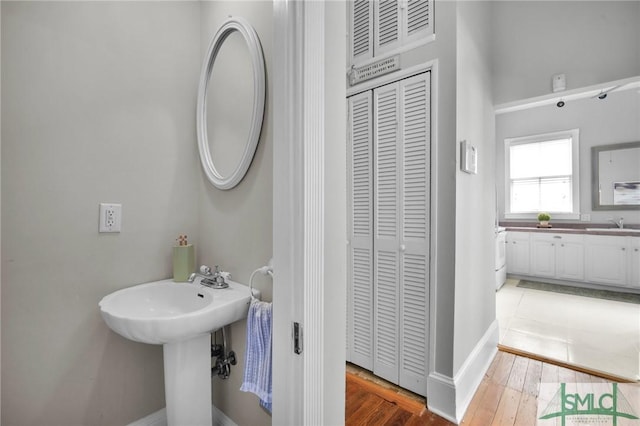 bathroom with wood-type flooring and sink