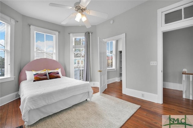 bedroom with dark wood-type flooring and ceiling fan