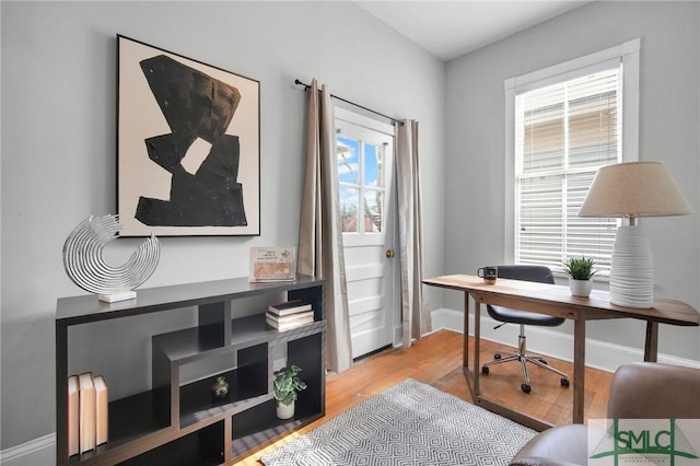 office area with light hardwood / wood-style floors