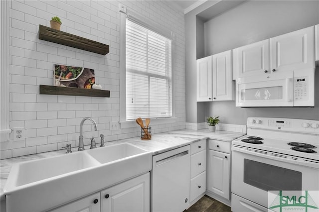 kitchen featuring light stone counters, white appliances, sink, and white cabinets