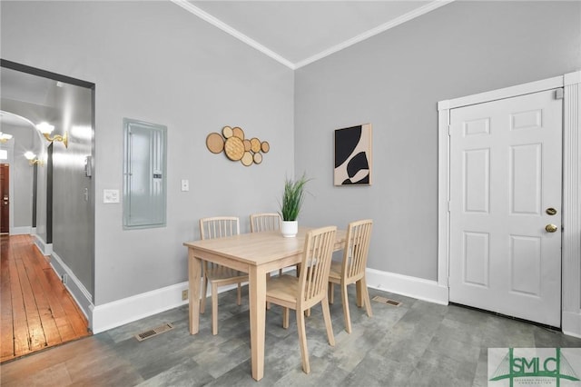 dining space with lofted ceiling, ornamental molding, electric panel, and wood-type flooring