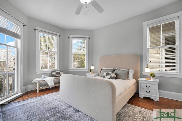 bedroom with dark hardwood / wood-style floors and ceiling fan