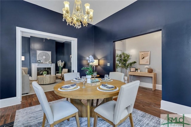 dining room with hardwood / wood-style flooring and a chandelier