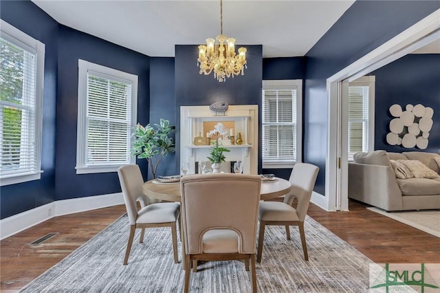 dining area featuring an inviting chandelier and hardwood / wood-style floors