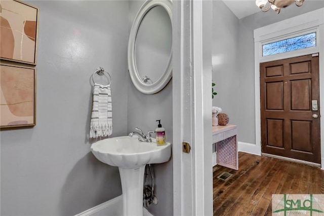 bathroom with hardwood / wood-style floors