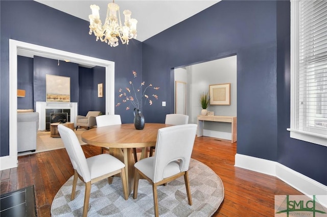 dining space featuring a chandelier and dark hardwood / wood-style flooring