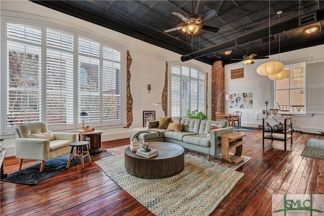 living room with wood-type flooring, a healthy amount of sunlight, and ceiling fan