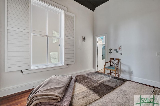 sitting room with dark wood-type flooring