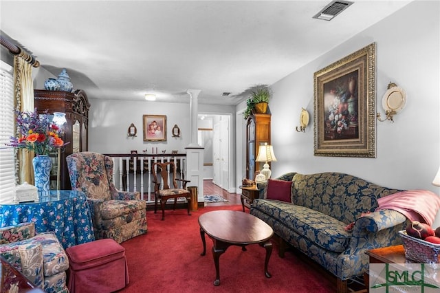 living room with decorative columns and carpet floors