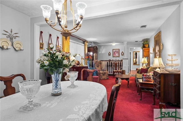 carpeted dining room with a chandelier