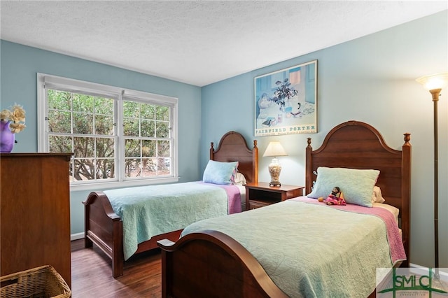 bedroom featuring dark hardwood / wood-style floors and a textured ceiling