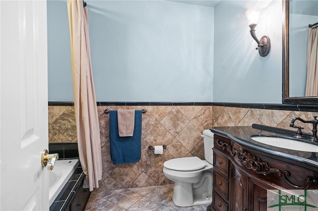 full bathroom featuring vanity, tile walls, shower / bathtub combination with curtain, and toilet