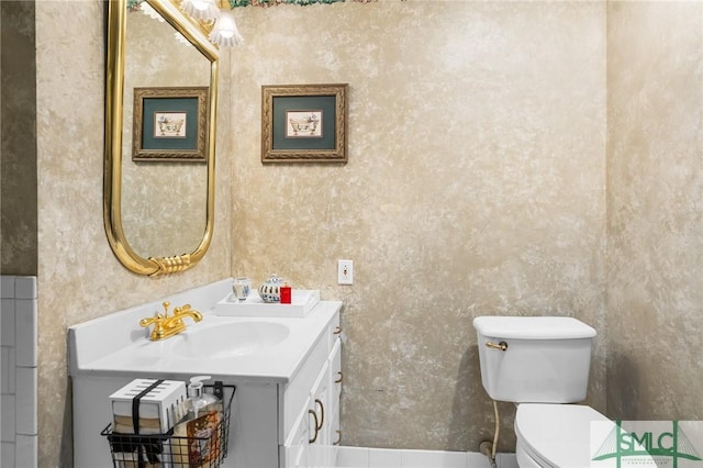 bathroom featuring vanity and toilet