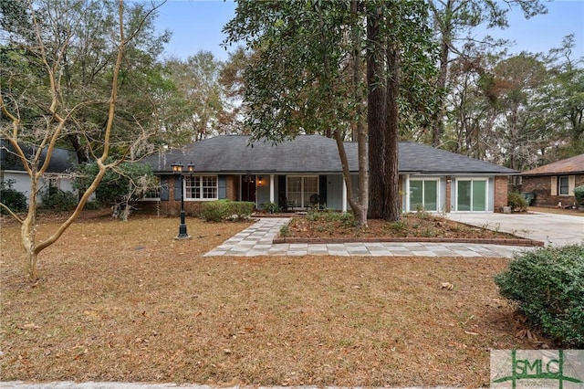 ranch-style home with a garage and a front yard