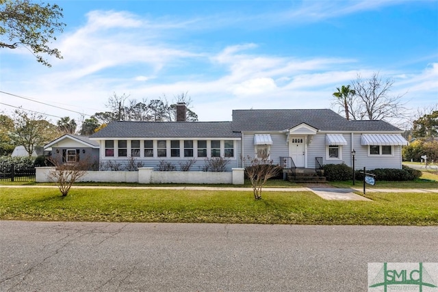 ranch-style home with a front lawn