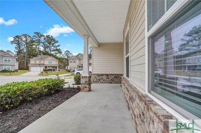 view of patio / terrace featuring a garage and covered porch