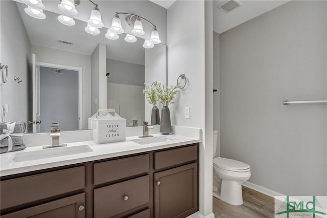 bathroom featuring hardwood / wood-style flooring, vanity, and toilet