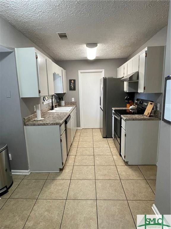 kitchen with range with electric cooktop, light tile patterned flooring, white cabinetry, sink, and stainless steel dishwasher