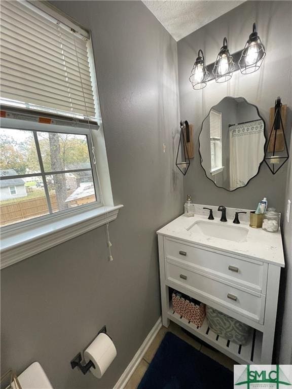 bathroom featuring vanity and a textured ceiling