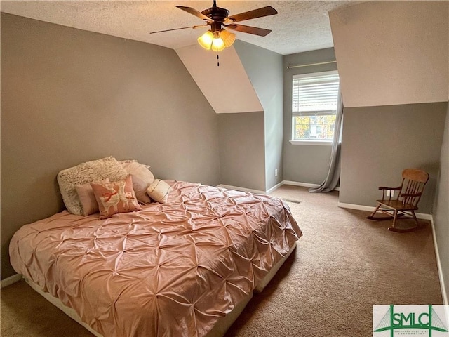 bedroom featuring ceiling fan, vaulted ceiling, a textured ceiling, and carpet