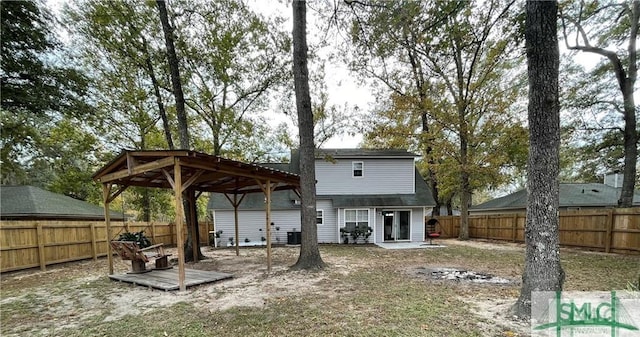 rear view of house featuring central AC