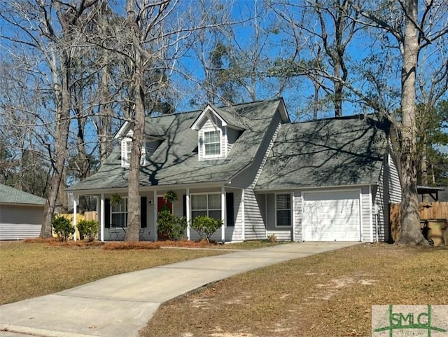 cape cod house featuring a front lawn, concrete driveway, a porch, and an attached garage