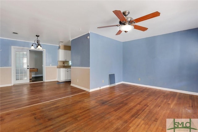 108 Stafford St, Hinesville, GA 31313 - unfurnished living room with ceiling fan with notable chandelier and dark wood-type flooring