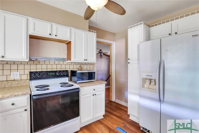 108 Stafford St, Hinesville, GA 31313 - kitchen with white cabinetry, electric range oven, tasteful backsplash, ventilation hood, and white fridge with ice dispenser