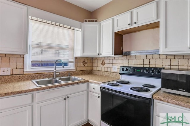 108 Stafford St, Hinesville, GA 31313 - kitchen featuring tasteful backsplash, white cabinetry, sink, and electric stove