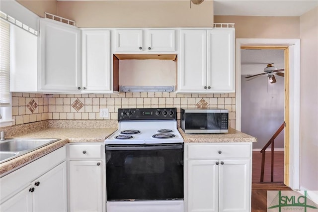108 Stafford St, Hinesville, GA 31313 - kitchen with white cabinetry, tasteful backsplash, range with electric cooktop, and ceiling fan