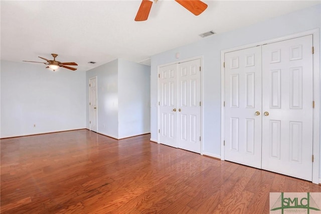108 Stafford St, Hinesville, GA 31313 - unfurnished bedroom with hardwood / wood-style flooring, two closets, and ceiling fan