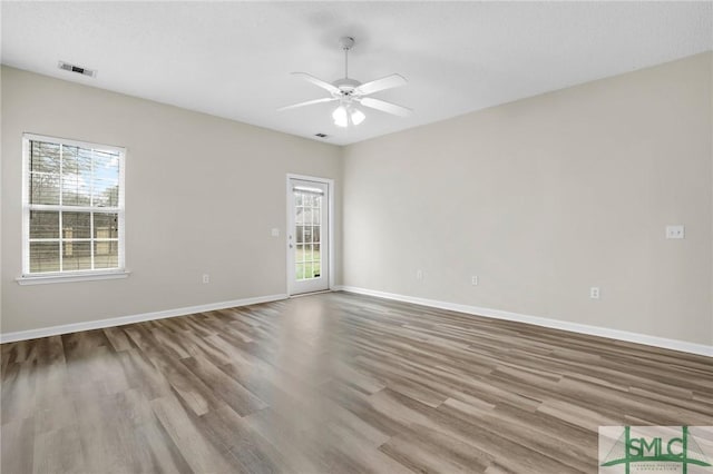 unfurnished room featuring ceiling fan, a healthy amount of sunlight, and light hardwood / wood-style flooring