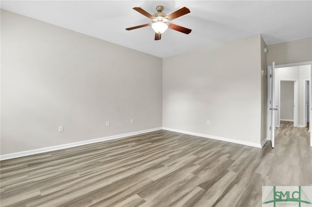 unfurnished room featuring light hardwood / wood-style flooring and ceiling fan