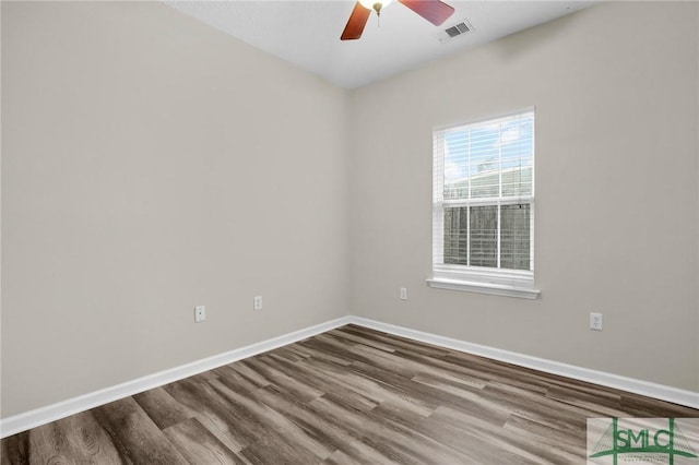 empty room with hardwood / wood-style floors and ceiling fan