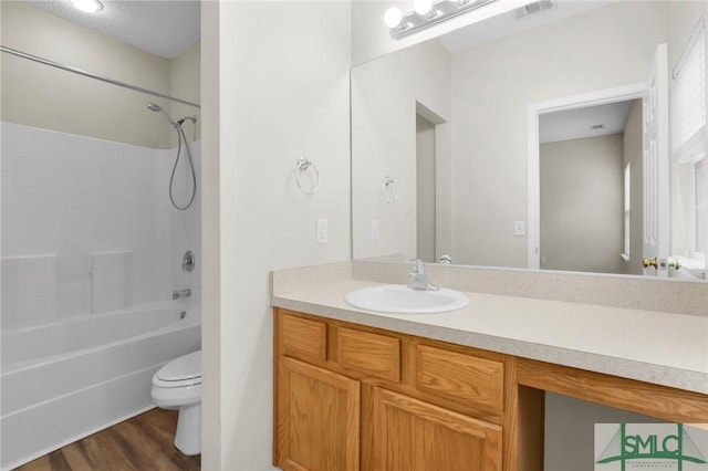 full bathroom featuring hardwood / wood-style flooring, vanity, toilet, and shower / bathing tub combination