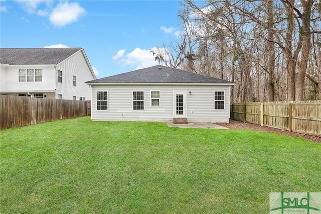 rear view of house featuring a lawn and a patio