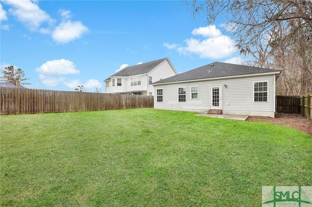 rear view of house with a yard and a patio area