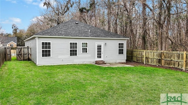 rear view of property featuring a yard and a patio