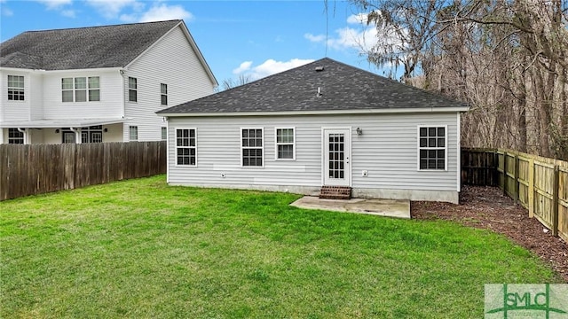 back of house with a yard and a patio area