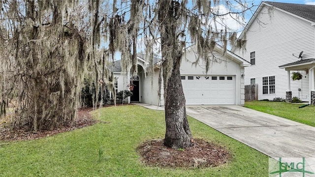 view of front of home with a garage and a front lawn