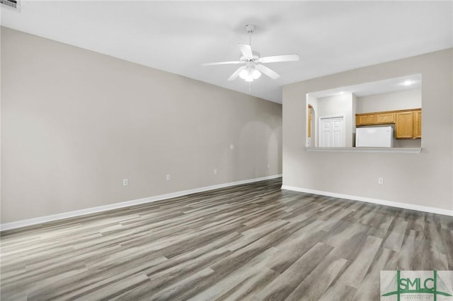 unfurnished living room featuring light hardwood / wood-style flooring and ceiling fan