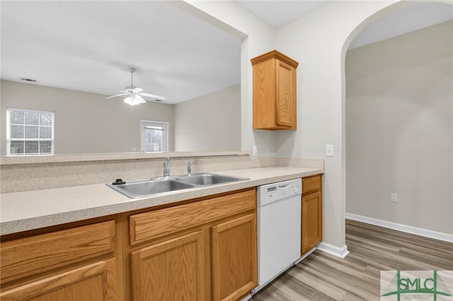 kitchen with dishwasher, sink, a wealth of natural light, and light hardwood / wood-style floors